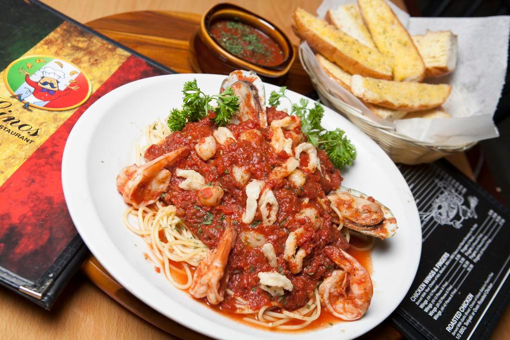 Ultimate Seafood Linguine · Baby clams, mussels, scallops, calamari and jumbo shrimp, smothered in a light clam or marinara sauce with garlic and wine.