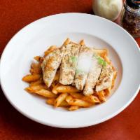 Penne Vodka Sauce · Penne pasta with prosciuttini in pink sauce, finished with vodka and topped with imported Pa...