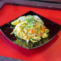Pineapple Fried Rice · Stir-fried jasmine rice with meat of choice, egg, onion, carrots, cashew nuts, pineapple and...