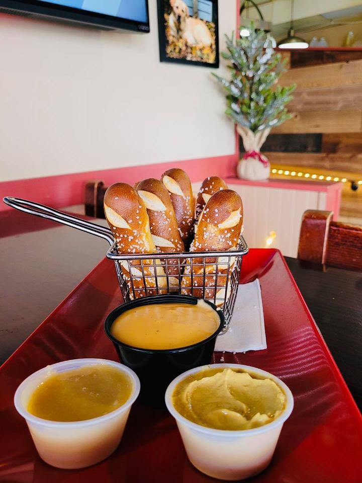 Pretzel Sticks · Fresh baked pretzels served with dipping sauces including our popular warm beer cheese.