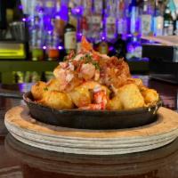 Lobster Tots · Hot lobster meat stacked on crispy bacon, stacked on warm beer cheese, stacked on toasty tots