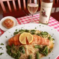 Grilled Salmon Platter Dinner · Fresh salmon filet, sauteed asparagus, white wine lemon sauce and angel hair pasta.