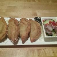 Thai Samosa · Yellow curry puffs stuffed with potato, carrot and onion. Served with fresh cucumber salad.