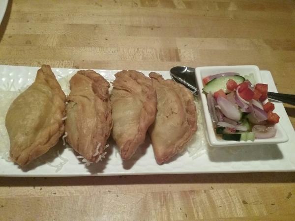 Thai Samosa · Yellow curry puffs stuffed with potato, carrot and onion. Served with fresh cucumber salad.