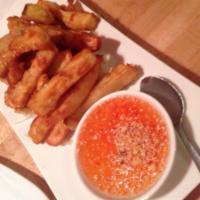 Mun-Tod · Sweet potato dipped in coconut butter deep-fried and served with sweet and sour sauce topped...