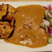 Thai Satay · Grilled marinated chicken strips in skewers with Thai curry powder, served with fresh cucumb...