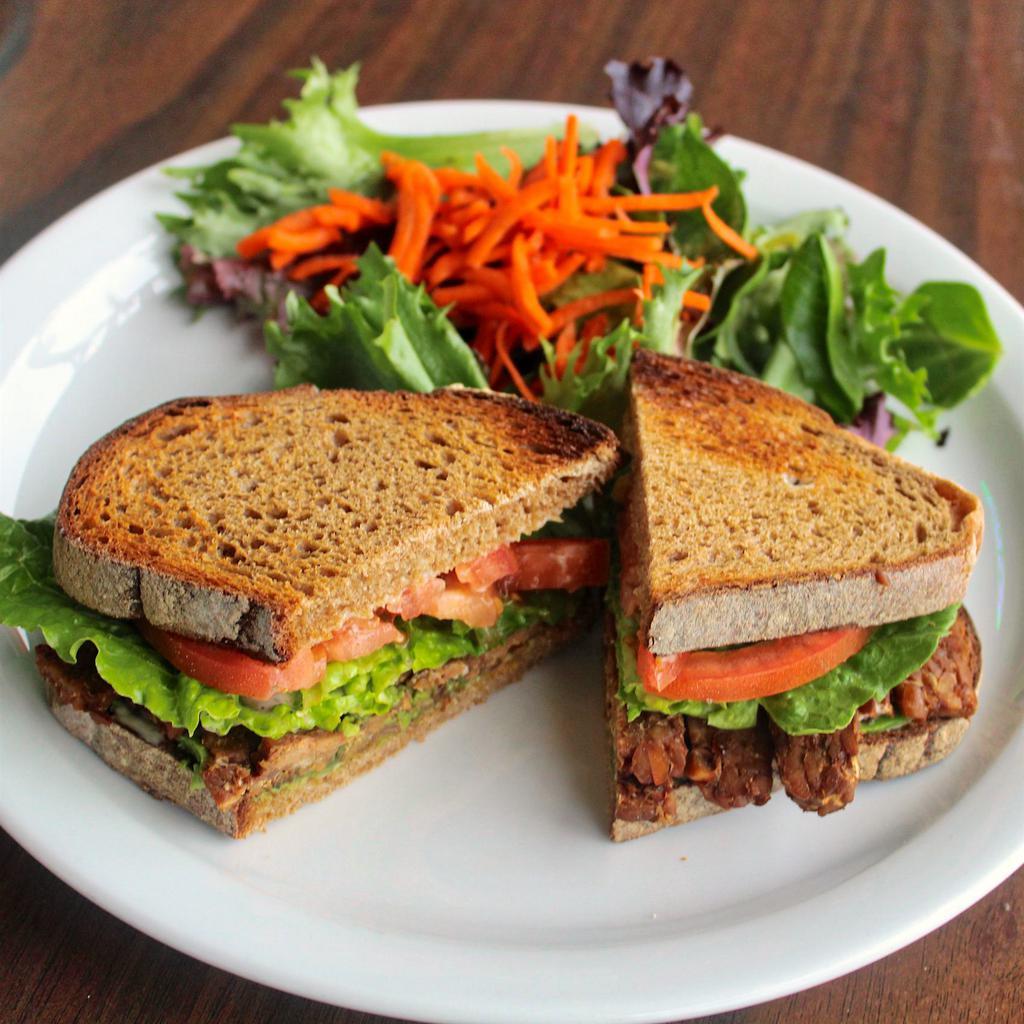 TBLAT Sandwich · Garlic aioli and ranch, avocado, tomato, tempeh bacon, and romaine lettuce between 2 slices of Grand Central bread comes with a side salad served with cilantro lime vinaigrette.