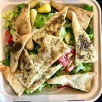 Fattoush Salad · A Mediterranean fried bread salad includes lettuce, tomatoes, cucumbers, radishes, green pep...