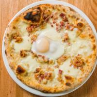 Carbonara Pizza · White pizza with bacon, mozzarella cheese and eggs.