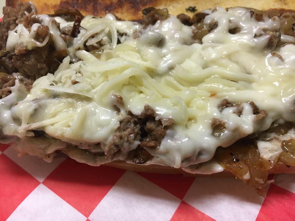 Philly Cheesesteak · Shaved ribeye, sauteed onions, mushrooms and cream cheese. Topped with our special blend of cheeses.