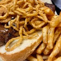 Black and Blue Ribeye Sandwich · Cajun ribeye topped with blue cheese butter and fried onions. Served on a hoagie bun.