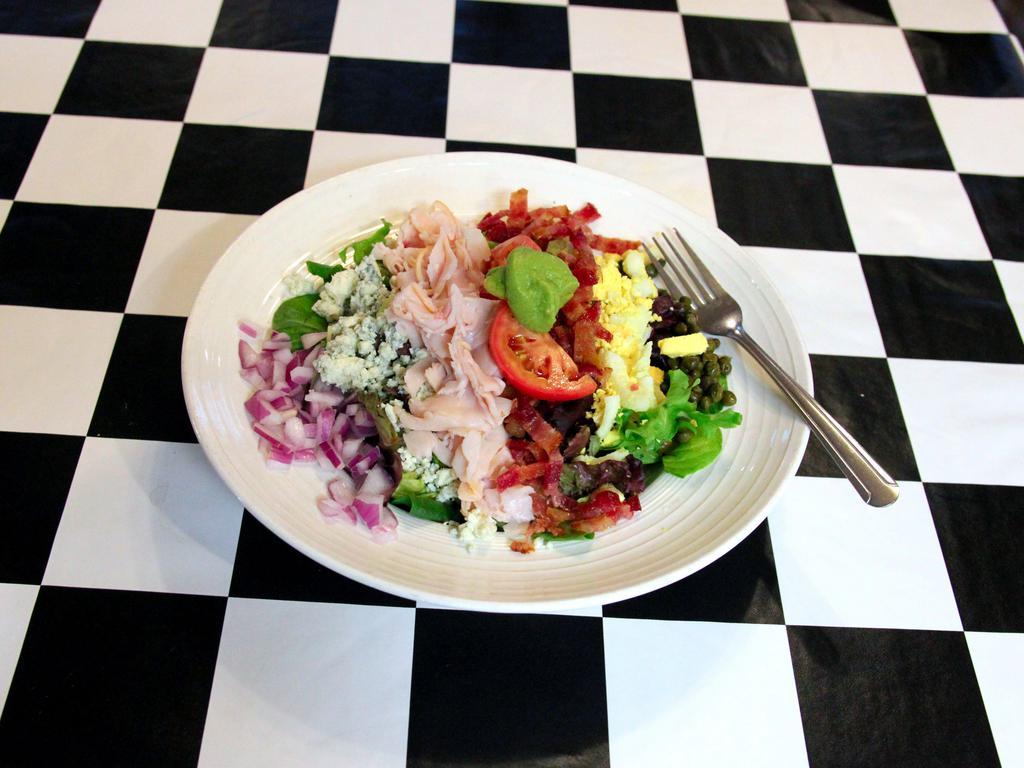 Cobb Salad · Bacon, turkey, bleu cheese, red onion, tomato, egg, guacamole and capers.