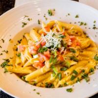 Rattlesnake Pasta · Penne pasta tossed with grilled chicken breast tossed in our Cajun cream sauce and topped wi...