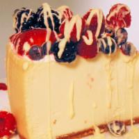 Mixed Berry Cheesecake · Our New York style cheesecake topped with fresh seasonal berries drizzled with white chocola...