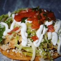 Tostada · With chicken, lettuce, queso fresco, refried beans, sour cream, and chipotle sauce.