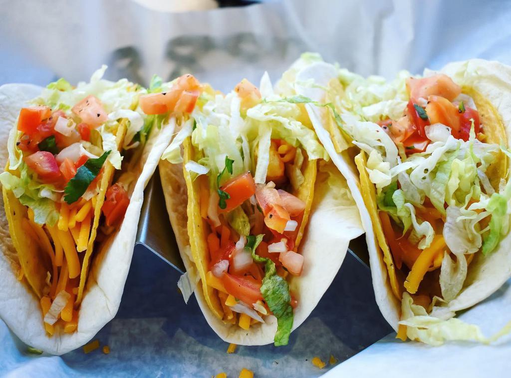 Taco Taco · 3 pieces. hard shell tacos, seasoned ground beef, cheddar cheese, lettuce, and tomato wrapped in sour cream covered flour tortillas.