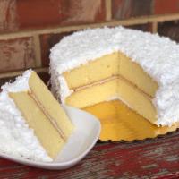 Coconut Cake · Moist yellow layer cake filled with coconut cream, covered in divinity icing and shredded fl...