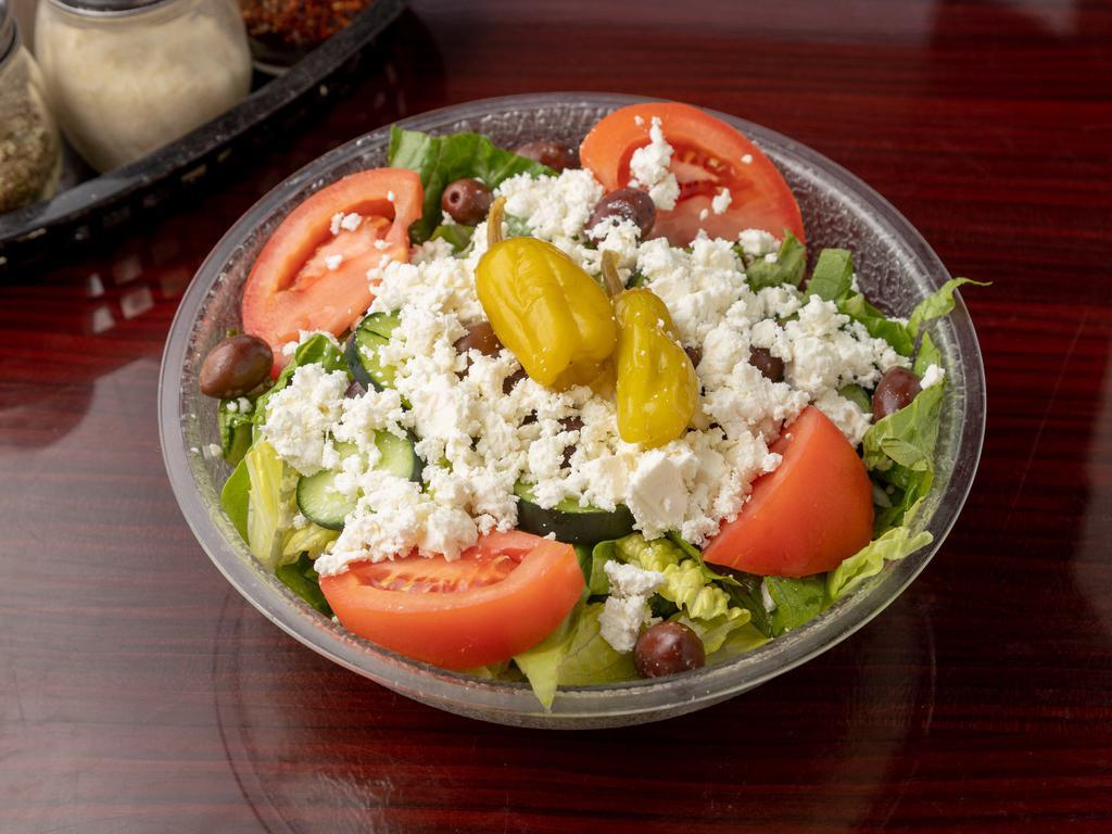 Greek Salad · Romaine lettuce, tomatoes, cucumbers, red onions, feta cheese, and pepperoncini served with our house Greek dressing.