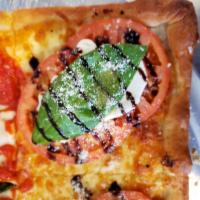 Large Crustino Pizza · Square, thin, garlic crust pizza, topped with more fresh garlic, fresh tomato slices, fresh ...
