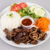 Rice Plate · Com. Served with jasmine rice, cucumbers, pork eggroll, tomatoes, lettuce and pickled carrots.