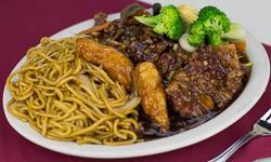 Orange Chicken and Beef Combo · White meat chicken and beef, breaded and deep fried with sauce. Served with lo mein and vege...