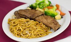 Grilled Veal · Marinated and grilled veal served with vegetables and lo mein on the side.