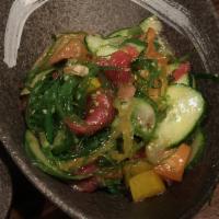 Poke Salad · Raw fish, avocado, cucumber, seaweed salad and chef sauce.