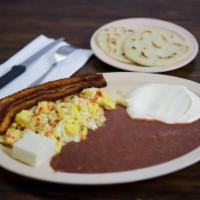 Desayuno Salvadoreno Tipico · Traditional Salvadorian breakfast served with 2 eggs, plantains, 1 piece of hard cheese, bea...