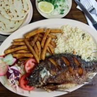 Mojarra · Fried whole tilapia served with rice, fries, 2 hand made tortillas and a salad.