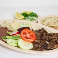 Carne Asada · Grilled steak served with salad, beans, rice, and 2 hand made tortillas.