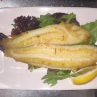 Grilled Sole · A delicate and mild filet of sole pan seared and served on a miso-dressed bed of organic mix...