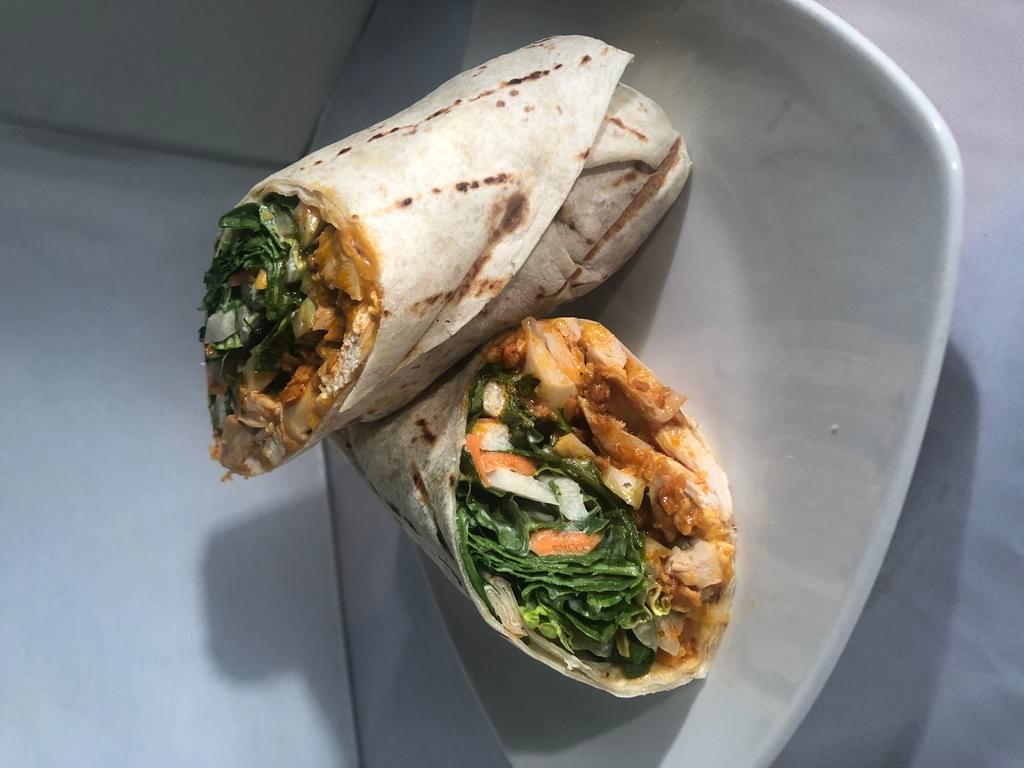 Buffalo Chicken Ranch Wrap · Grilled Chicken Tenders tossed in Buffalo Sauce with Cheddar Cheese, Buttermilk Crispies, and a Ranch dressed salad with Carrots and Celery... ALL wrapped in a tortilla and grilled.