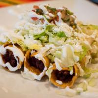 Flautas · Stuffed crispy rolled tortillas topped with lettuce, sour cream, cheese & pico de gallo (3 p...