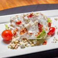 Wedge Salad · Iceberg wedge topped with blue cheese crumbles, bacon & hard boiled eggs.  Served with house...