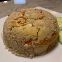 23C. Pineapple Fried Rice · Eggs, curry powder, pineapple, cashews and onions.
