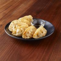 04. Chicken Pot Stickers · Steamed or deep-fried ground chicken wrapped in wonton skin, served with sweet soy sauce.