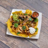 Super Nachos · Choices of seasoned ground beef, chicken or vegetarian with cheddar and Jack cheese, jalapen...