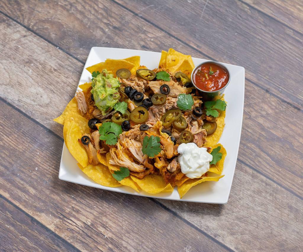 Super Nachos · Choices of seasoned ground beef, chicken or vegetarian with cheddar and Jack cheese, jalapeno, black olives and beans topped with guacamole and sour cream.