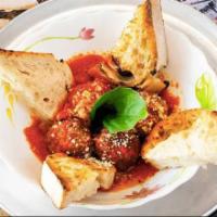 Meatballs Polpette · 100% beef meatballs in tomato ragu with parmigiano and basil, Served with Home Made Bread