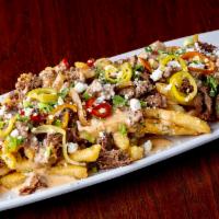 Willy Filly FF · Garlic FF topped with Queso, pickled chilies, Shaved ribeye, grilled onions, red peppers and...