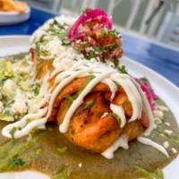 Wade's Chimichanga  · Golden brown deep fried burrito, green chile chicken, beans, melted cheese blend, avocado sp...