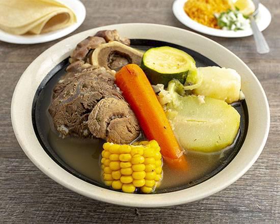Caldo De Res  · Beef Shank soup with potatoes carrots corn squash, served with a side of rice onions and tortillas.