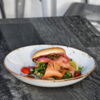 Salmon Bagel · Atlantic smoked salmon on a bagel with beet whipped cream cheese, pickled red onion, cherry ...