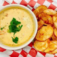 Crawfish Queso · Served with Potato Chips