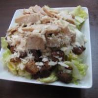 Chicken Caesar Salad · Lettuce, Parmesan cheese crouton and grilled chicken and Caesar dressing on the side.
