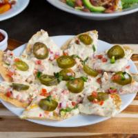 Chicken Jack Nachos · Crispy tortillas covered with chicken, hot pepper cheese, and jalapenos. Served with our fre...