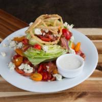 The Wedge Salad · Crisp iceberg lettuce with red and yellow grape tomatoes, bacon, bleu cheese crumbles and to...
