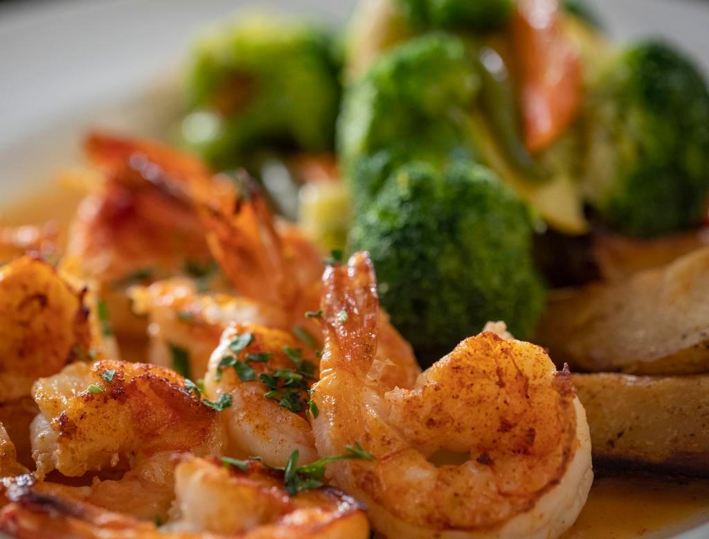 Shrimp Scampi (8) · Shrimp sauteed in garlic, olive oil and white wine. Served with potato and vegetable of the day.