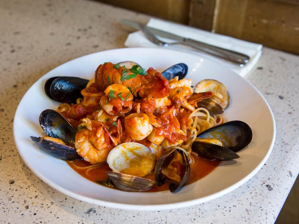 Zuppa Di Pesce · Shrimp clams, mussels, lobster tail and calamari sauteed in marinara sauce and served over linguini.