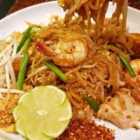 Country Pad Thai · Hot and spicy stir fried rice noodles with chicken, shrimp, egg, tofu, bean sprouts and scal...